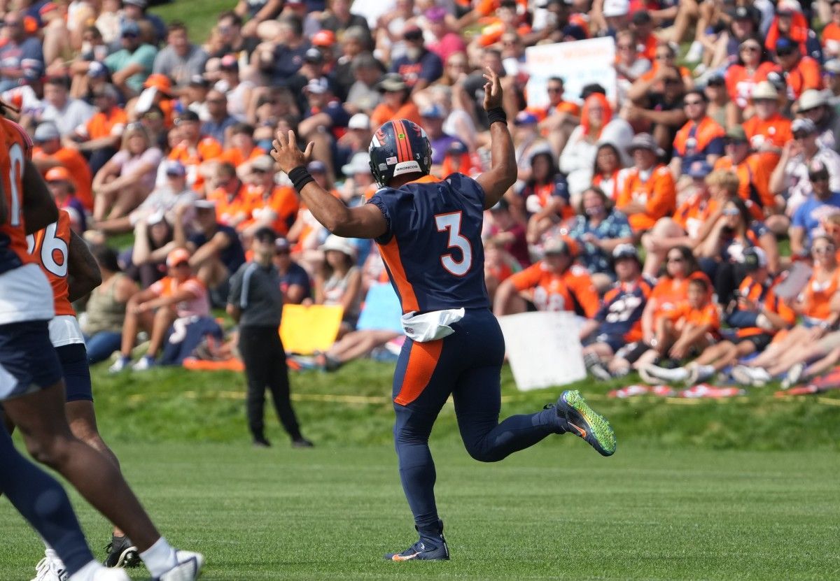 Denver Broncos quarterback Russell Wilson (3) reacts toward the fans during training camp at the UCHealth Training Center.
