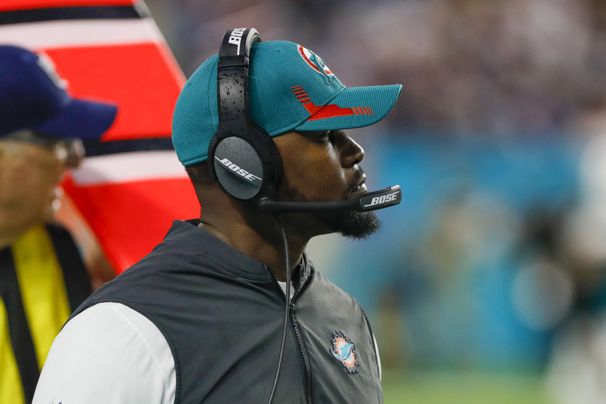 Brian Flores wearing a dolphins hat and headset
