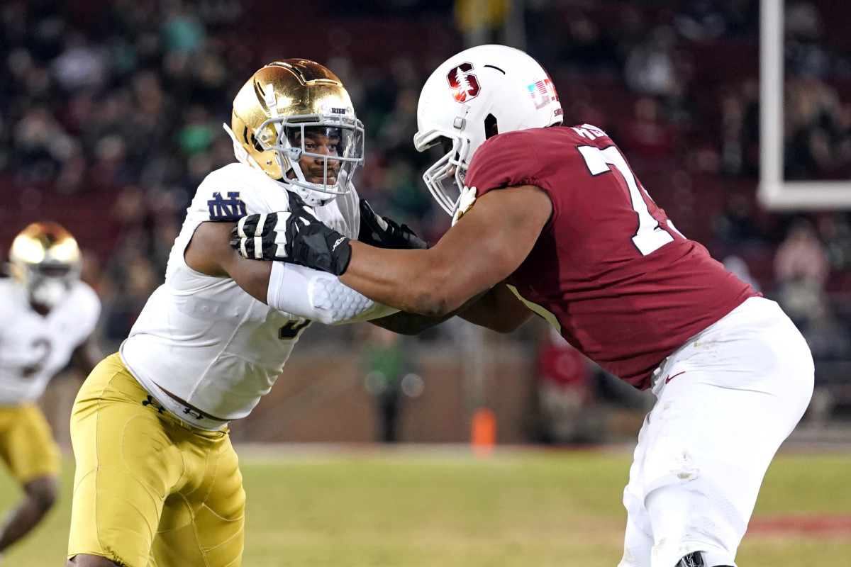 Nov 27, 2021; Stanford, California, USA; Notre Dame Fighting Irish defensive lineman Justin Ademilola (9) and Stanford Cardinal offensive tackle Walter Rouse (75) during the third quarter at Stanford Stadium. Mandatory Credit: Darren Yamashita-USA TODAY Sports