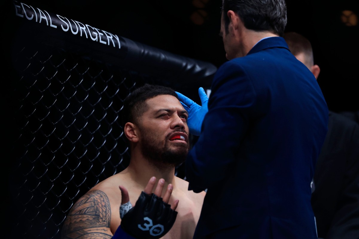 The Octagon-side doctor checks on Justin Tafa during his UFC Jacksonville fight with Austen Lane.