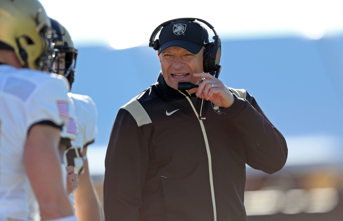 Army coach Jeff Monken relays a play to one of his players during a timeout.