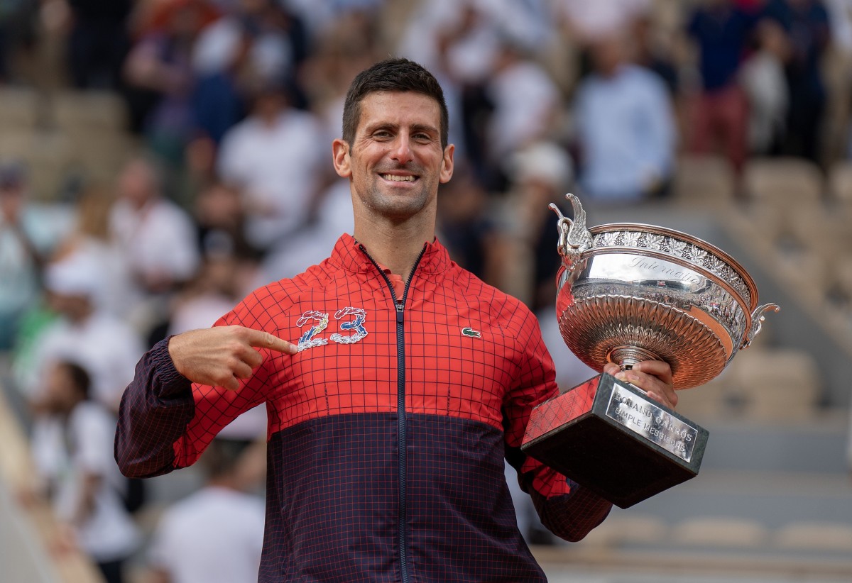 Novak Djokovic poses after winning his 23rd grand slam final