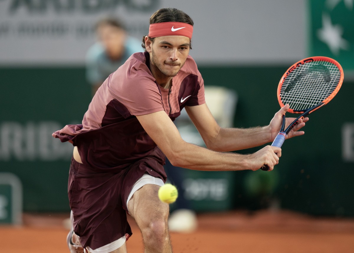 Taylor Fritz returns a shot during his match against Arthur Rinderknech