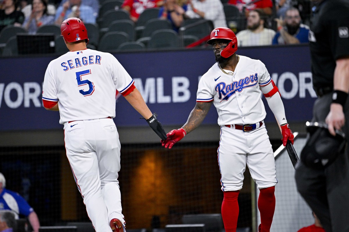Jun 3, 2023; Arlington, Texas, USA; Texas Rangers shortstop Corey Seager (5) and right fielder Adolis Garcia (53) celebrate after Seager scores against the Seattle Mariners during the second inning at Globe Life Field. Mandatory Credit: Jerome Miron-USA TODAY Sports