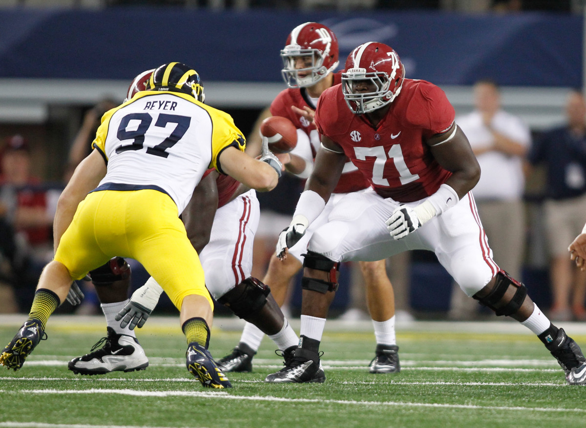 Alabama Crimson Tide left tackle Cyrus Kouandjio (71) on the line of scrimmage during the second quarter against the Michigan Wolverines during the 2012 season opener at Cowboys Stadium. Alabama beat Michigan 41-14.