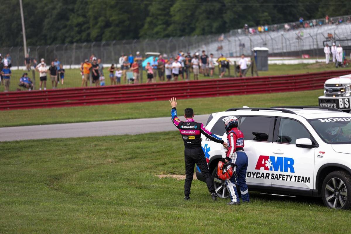 Simon Pagenaud waves to fans as he climbs into a safety vehicle to take a ride to the infield care center after a scary crash during IndyCar practice Saturday morning at Mid-Ohio Sports Car Course. Photo courtesy IndyCar.