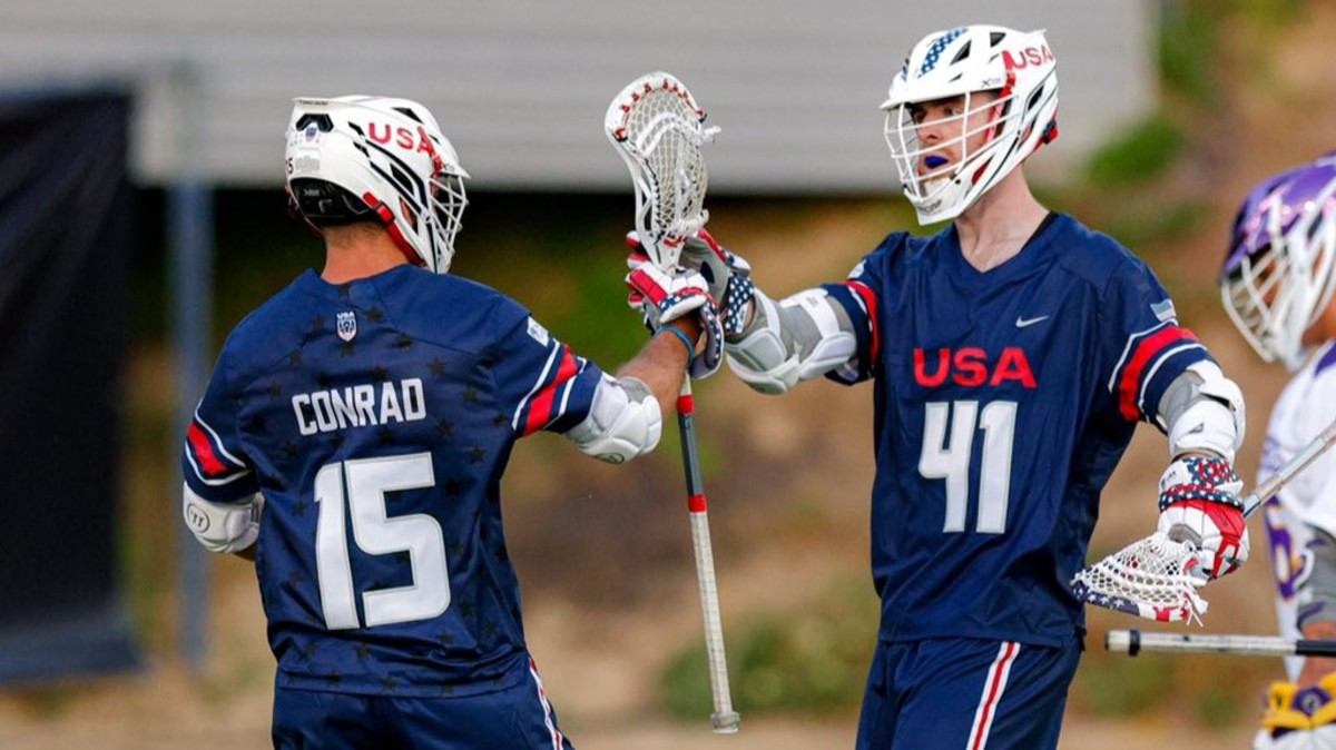 Former Virginia men's lacrosse players Ryan Conrad and Charlie Bertrand celebrate after a goal during the USA vs. Haudenosaunee game at the 2023 World Lacrosse Men's Championship in San Diego.