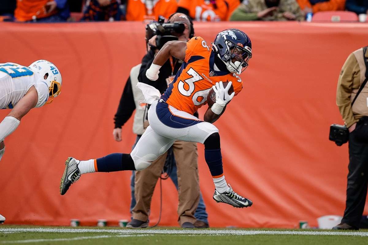 Denver Broncos running back Tyler Badie (36) runs for a touchdown on a reception in the third quarter against the Los Angeles Chargers at Empower Field at Mile High.