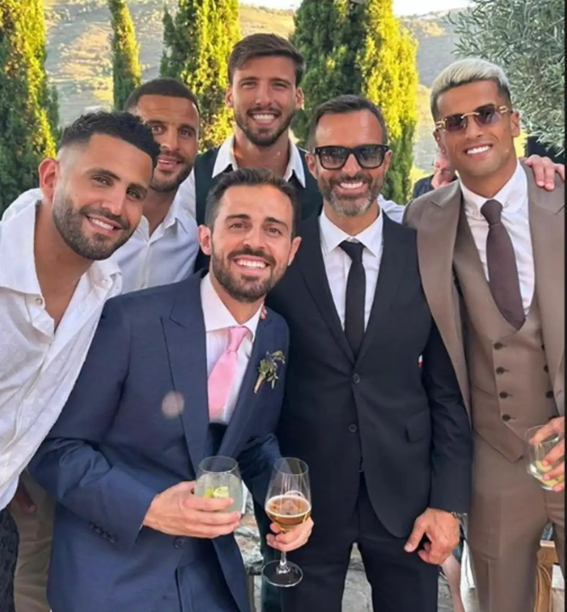 Joao Cancelo (right) posted this photo from the wedding of Bernardo Silva (pink tie) and Ines Tomaz (not pictured) in 2023. It also features (left to right) Riyad Mahrez, Kyle Walker, Ruben Dias and Jorge Mendes