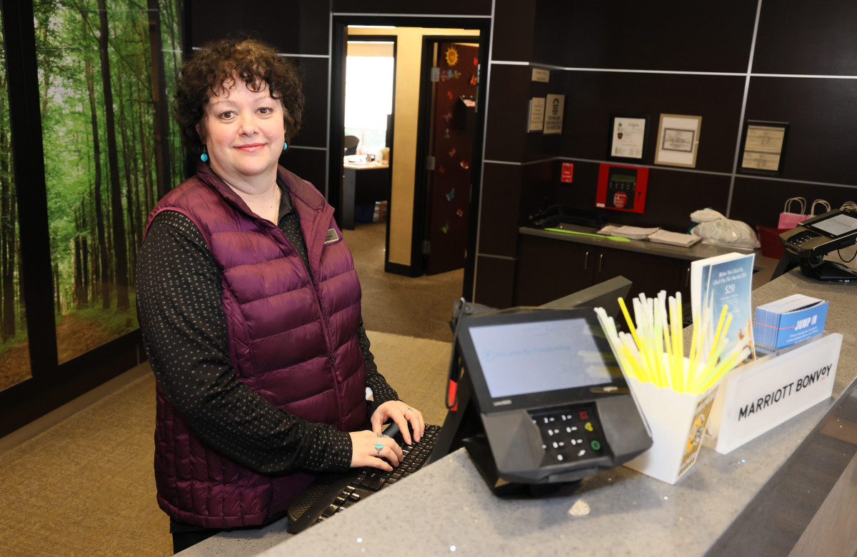 Packers fan Lawanna Lambert behind the desk at a Green Bay hotel.