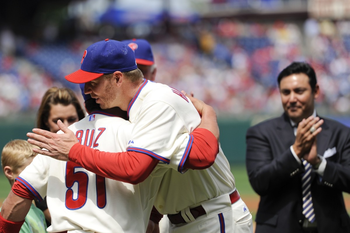 Philadelphia Phillies pitcher Roy Halladay (34) and catcher Carlos Ruiz (51) hug as the Phillies honor Halladay for his perfect game. (Howard Smith-USA TODAY Sports)