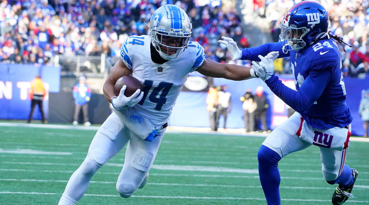 Amon-Ra St. Brown runs after the catch against the Giants