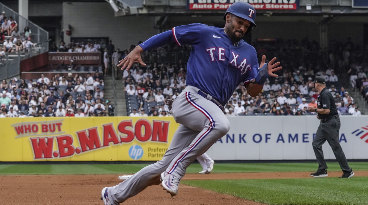 Rangers second baseman Marcus Semien digs for home.