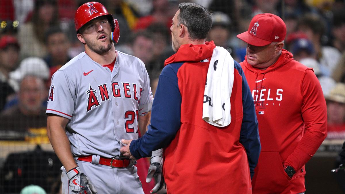 Los Angeles Angels center fielder Mike Trout is checked by a trainer