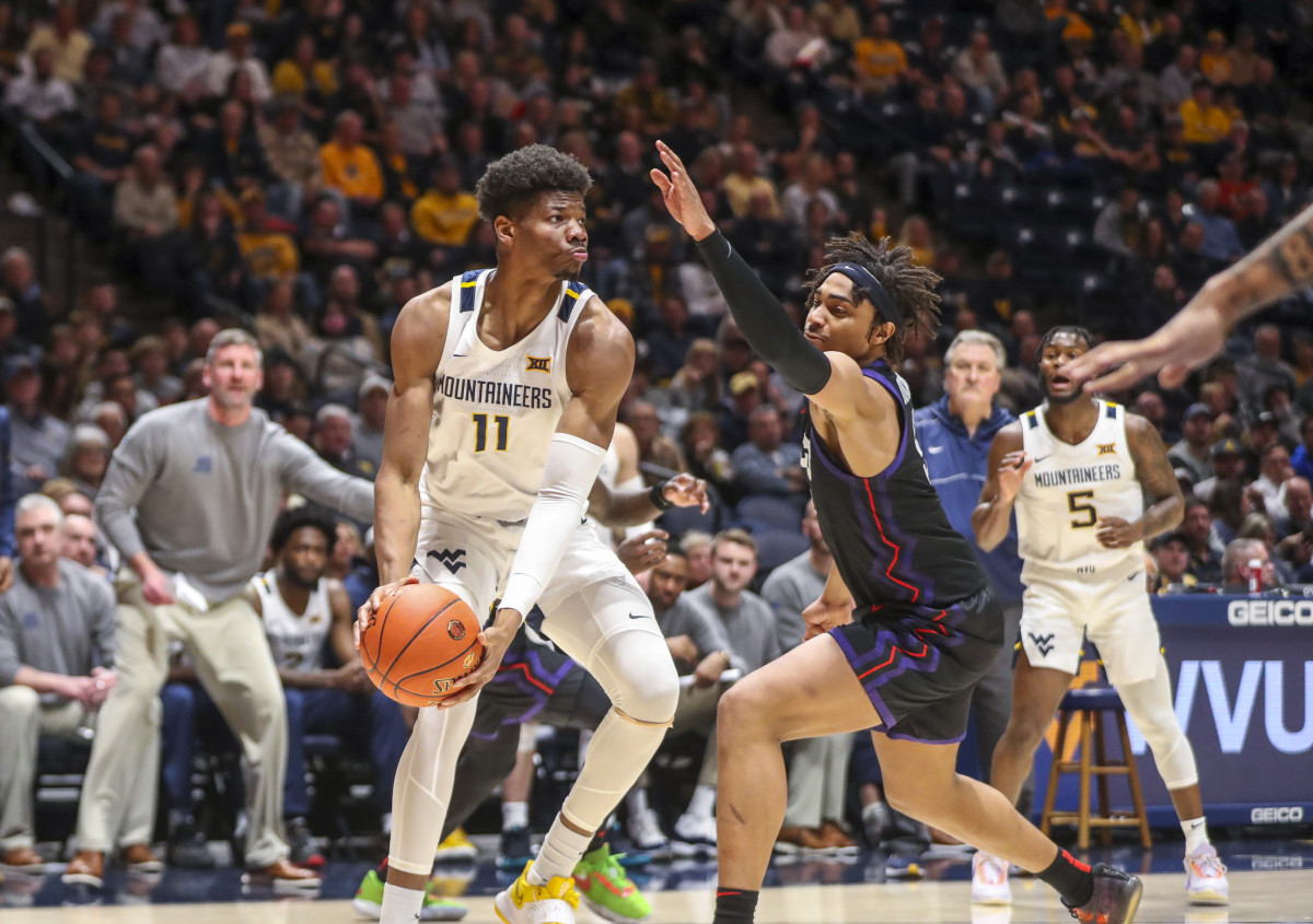 Jan 18, 2023; Morgantown, West Virginia, USA; West Virginia Mountaineers forward Mohamed Wague (11) looks to pass during the second half against the TCU Horned Frogs at WVU Coliseum. Mandatory Credit: Ben Queen-USA TODAY Sports