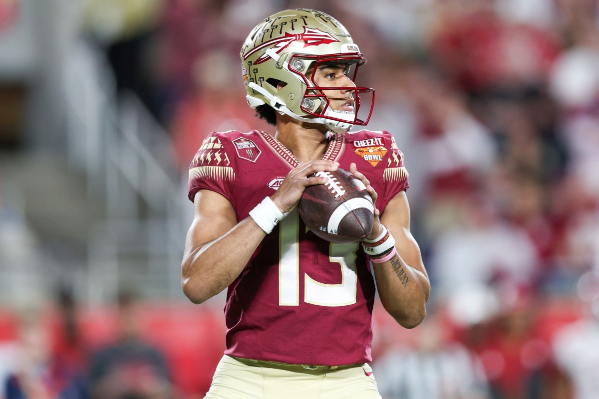 Florida State Seminoles quarterback Jordan Travis (13) drops back to pass against the Oklahoma Sooners in the second quarter during the 2022 Cheez-It Bowl at Camping World Stadium.