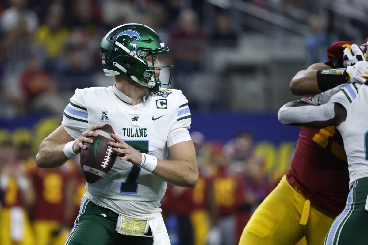Tulane Green Wave quarterback Michael Pratt (7) looks to throw a pass against the USC Trojans in the first quarter in the 2023 Cotton Bowl at AT&T Stadium.