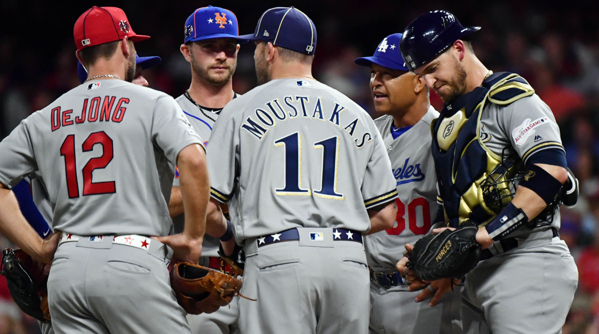 National League manager Dave Roberts of the Los Angeles Dodgers talks with his team during the seventh inning in the 2019 MLB All-Star Game.