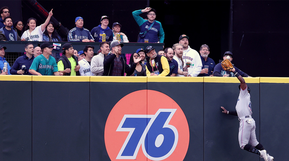 Marlins outfielder leaps at the wall to steal a home run at T-Mobile Park in Seattle.