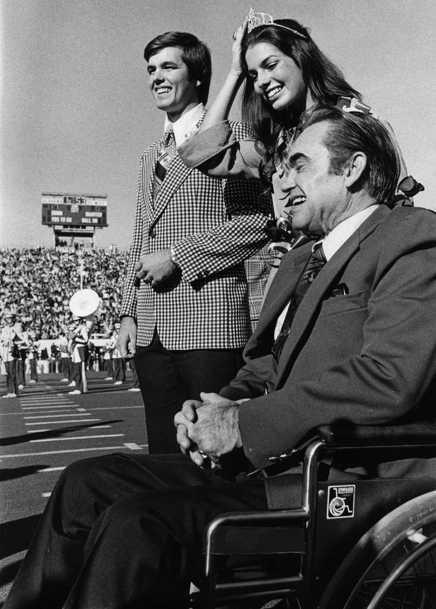 1975 University of Alabama homecoming queen Sela Ward and her escort Greg Wren stand beside Alabama Governor George Wallace at the 1975 homecoming game at Bryant Denny Stadium on the UA campus in Tuscaloosa, Ala., on Saturday November 15, 1975.