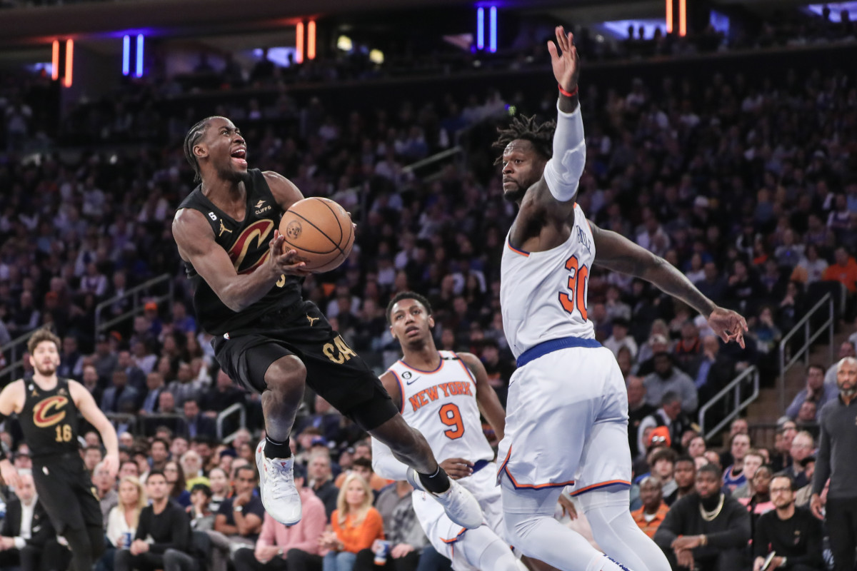 Curtis LeVert jumps with the ball in his hands looking to shoot as Julius Randle puts an arm up in front to guard him