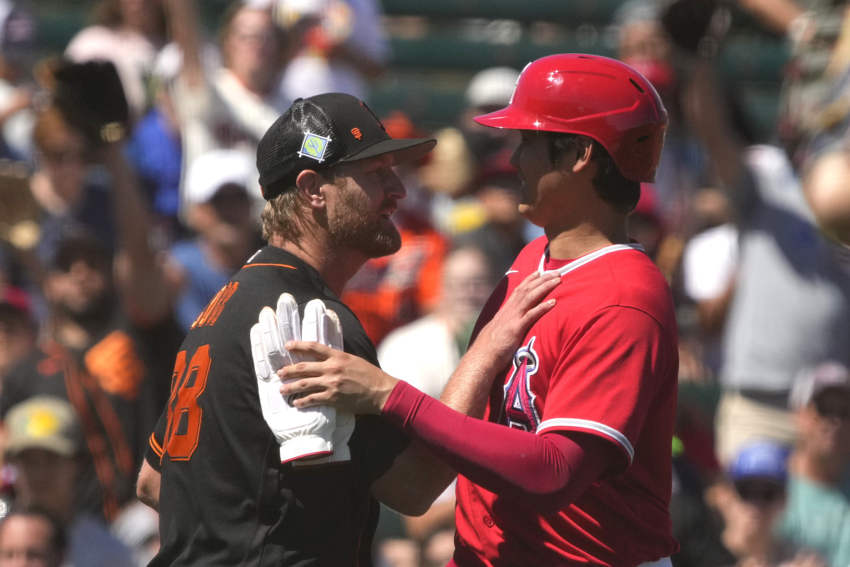 SF Giants starting pitcher Alex Cobb talks to Los Angeles Angels designated hitter Shohei Ohtani in between the innings during a spring training game at Tempe Diablo Stadium. (2022)