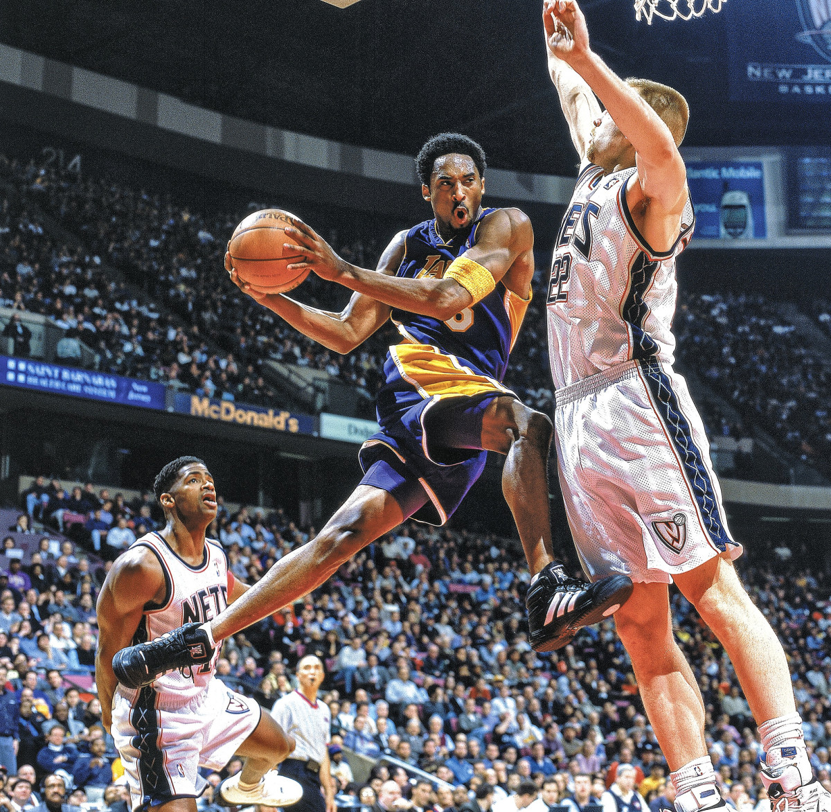 Kobe Bryant holding a basketball in mid-air