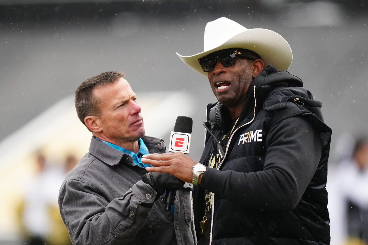 Colorado Buffaloes head coach Deion Sanders is interviewed by ESPN broadcaster Quint Kessenich during the first half of a spring game at Folsom Field