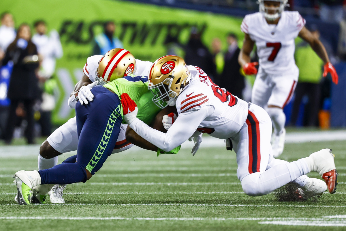 San Francisco 49ers defensive end Drake Jackson (95) and safety Tashaun Gipson Sr. (31) tackle Seattle Seahawks running back Kenneth Walker III (
