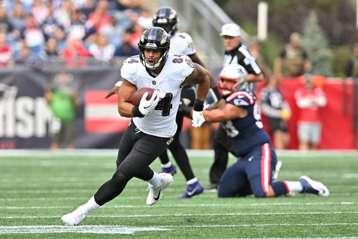 Sep 25, 2022; Foxborough, Massachusetts, USA; Baltimore Ravens tight end Josh Oliver (84) runs with the ball against the New England Patriots during the first half at Gillette Stadium.