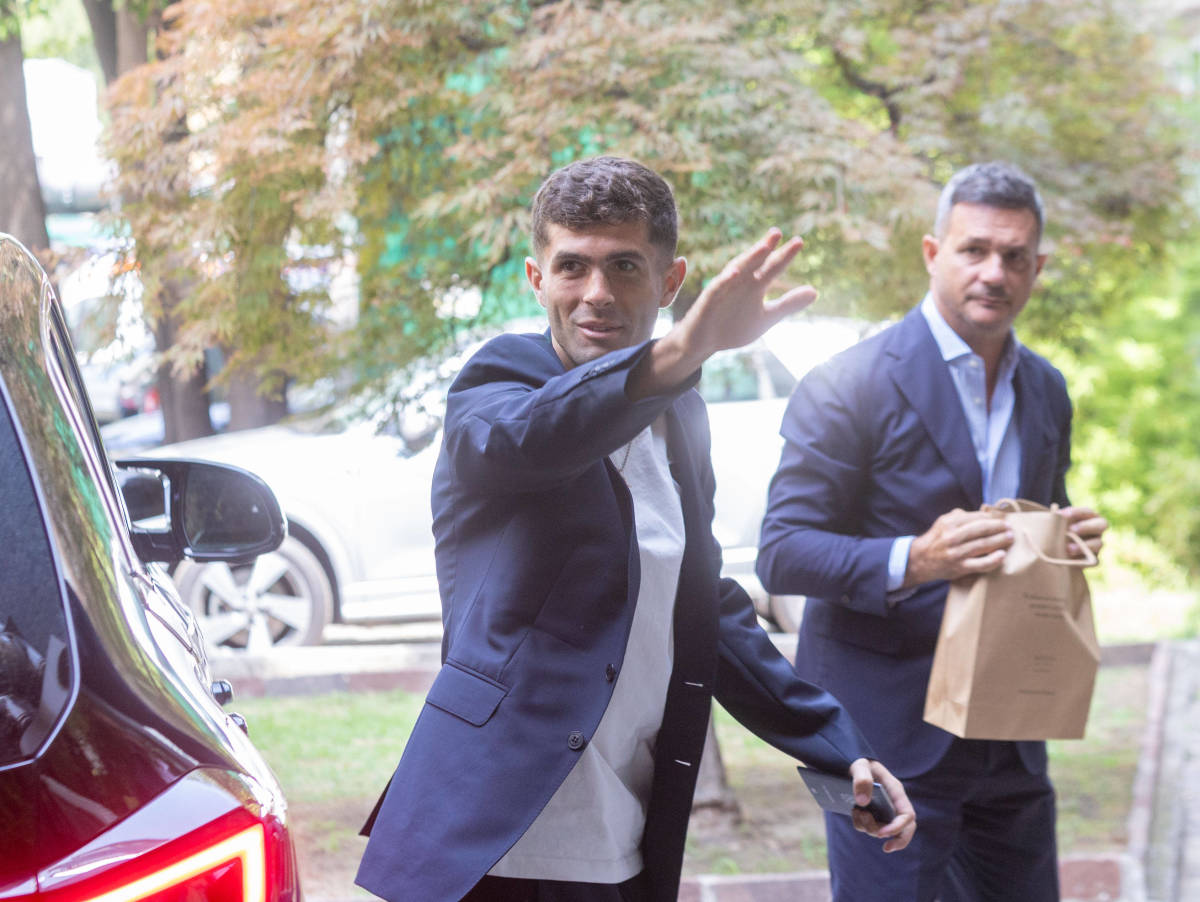 Christian Pulisic pictured waving to fans in July 2023 after arriving at AC Milan to complete his medical ahead of a transfer from Chelsea