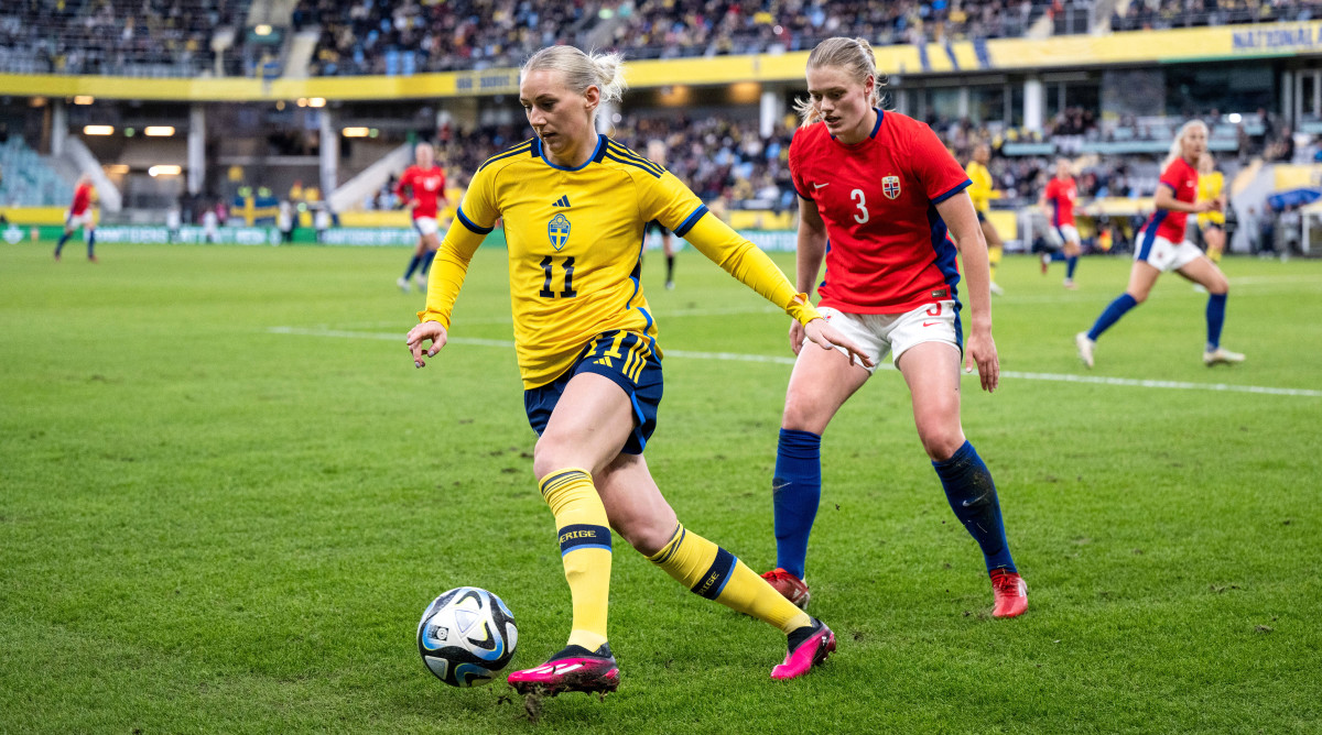 Sweden's Stina Blackstenius controls the ball and holds off Mathilde Harviken of Norway during a friendly.