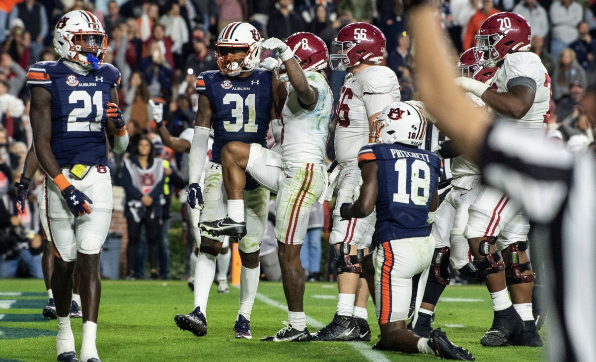 Alabama Crimson Tide wide receiver John Metchie III (8) celebrates his touchdown catch during overtime during the Iron Bowl at Jordan-Hare Stadium in Auburn, Ala., on Saturday, Nov. 27, 2021.