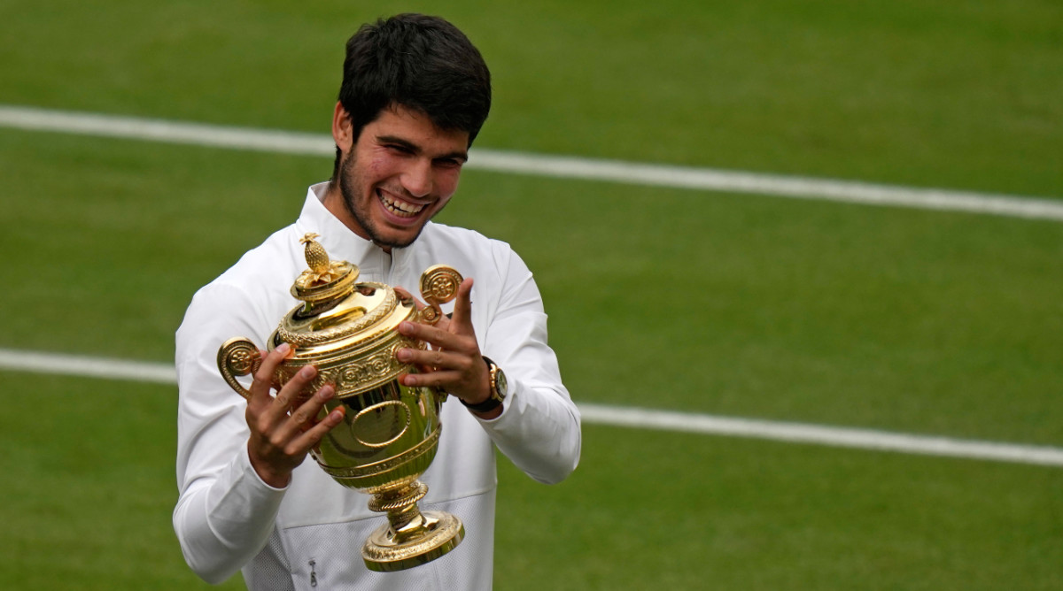 The 2023 Wimbledon champion Carlos Alcaraz holds the trophy after his win.