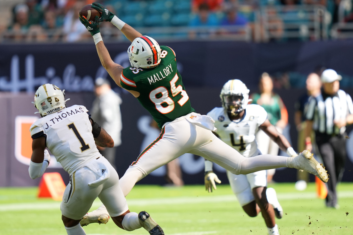 Nov 6, 2021; Miami Gardens, Florida, USA; Miami Hurricanes tight end Will Mallory (85) makes a catch in front of Georgia Tech Yellow Jackets defensive back Juanyeh Thomas (1) during the first half at Hard Rock Stadium. Mandatory Credit: Jasen Vinlove-USA TODAY Sports