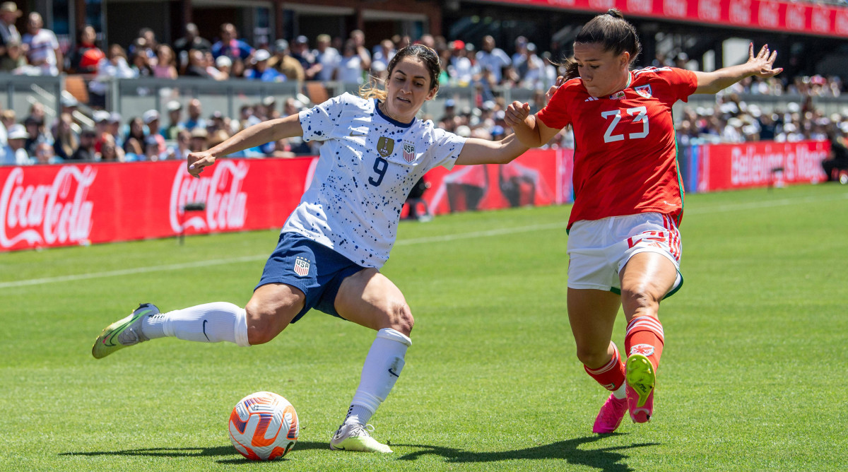 USWNT midfielder Savannah Demelo and Ffion Morgan of Wales battle for the battle in the USWNT's send-off game before the World Cup.