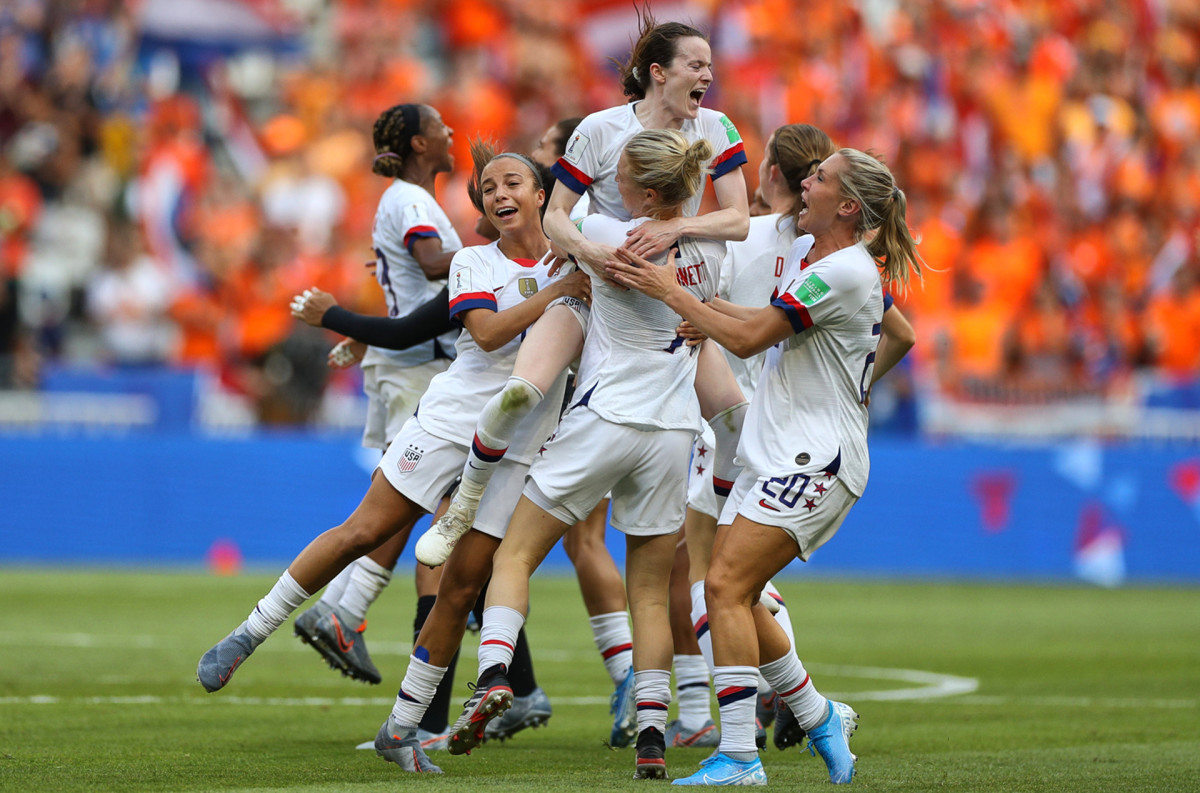 The USWNT celebrates on the field after defeating the Netherlands in the 2019 Women's World Cup.