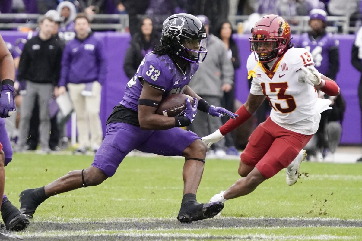 Nov 26, 2022; TCU Horned Frogs running back Kendre Miller (33) carries the ball against the Iowa State Cyclones. Mandatory Credit: Raymond Carlin III-USA TODAY Sports