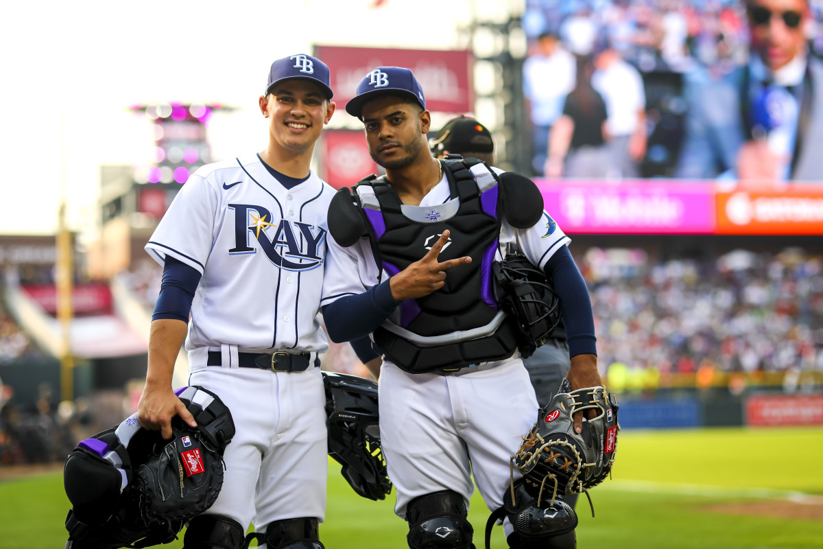 Catching in the 2021 Home Run Derby in Colorado was a thrill for Jean (top), one that he shared with Kinne (below, left), a fellow Rays staffer for whom he lobbied to also have a chance behind the plate.