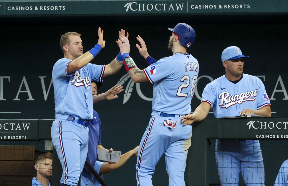 Texas Rangers catcher Jonah Heim (28) celebrates with Texas Rangers third baseman Josh Jung (6) after scoring during the fourth inning against the Los Angeles Dodgers at Globe Life Field.