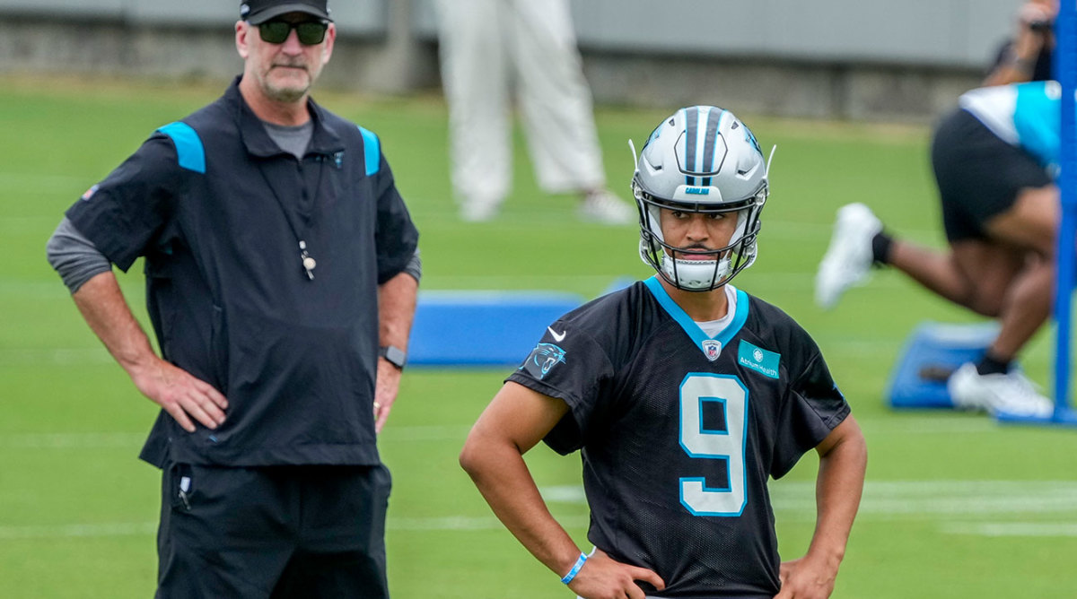Frank Reich looks on behind Bryce Young at OTAs
