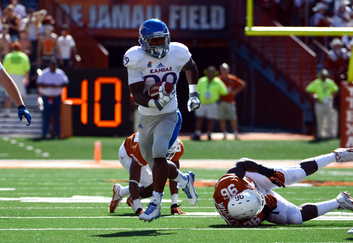 Nov 2, 2013; Austin, TX, USA; Kansas Jayhawks halfback James Sims (29) carries the ball against the Texas Longhorns during the first quarter at Darrell K Royal-Texas Memorial Stadium. Mandatory Credit: Brendan Maloney-USA TODAY Sports