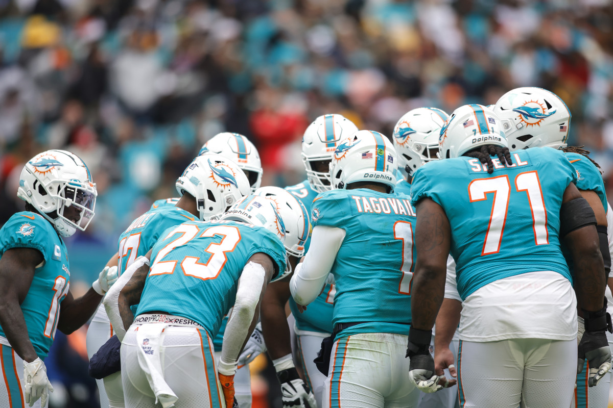 Dolphins players gather in a huddle