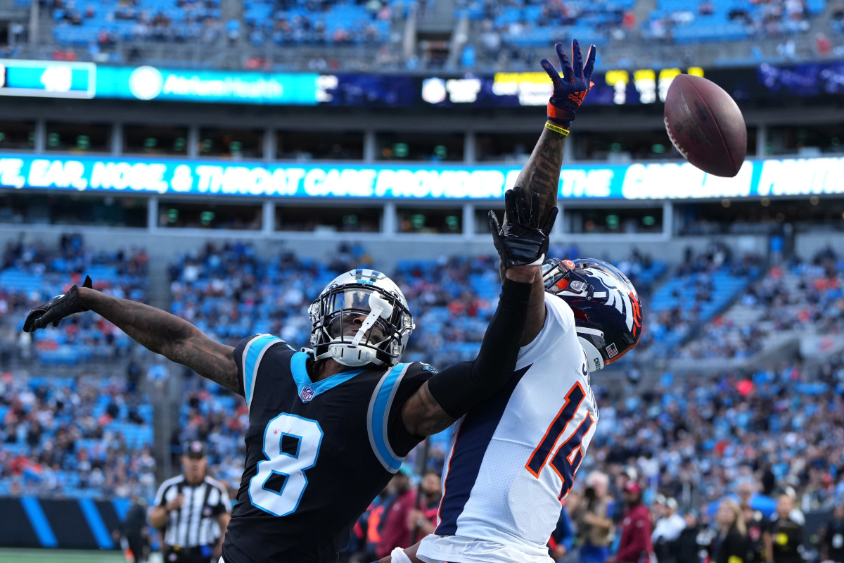 Carolina Panthers cornerback Jaycee Horn reaches up to break up a pass intended for Denver Broncos wide receiver Courtland Sutton
