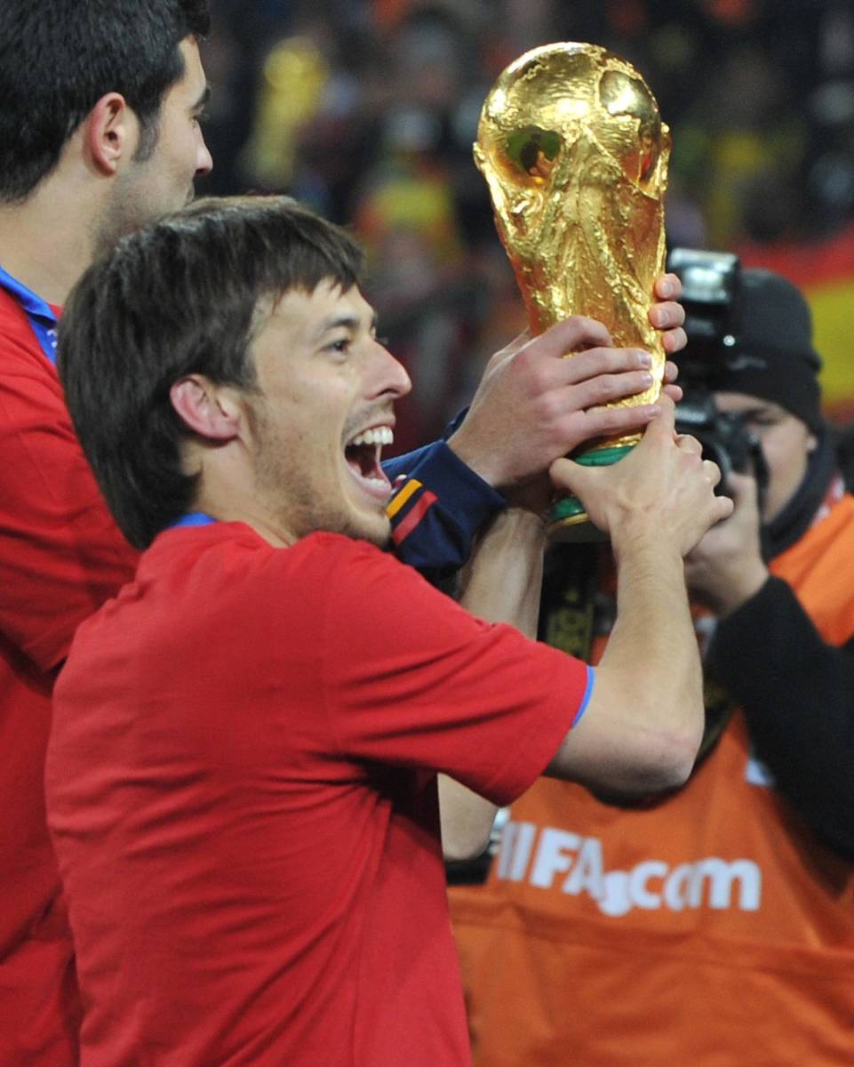 David Silva pictured holding the FIFA World Cup trophy after winning the tournament with Spain in 2010