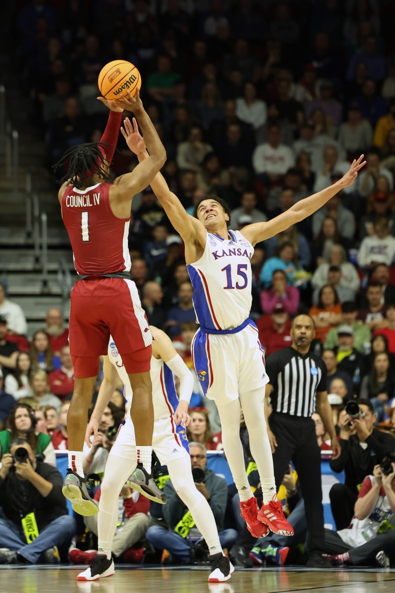 Arkansas Razorbacks guard Ricky Council IV shoots the ball against Kansas Jayhawks guard Kevin McCullar Jr.