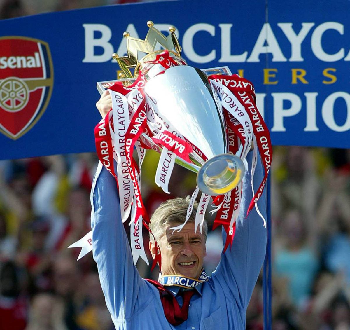 Arsene Wenger pictured lifting the Premier League trophy as Arsenal manager in 2004