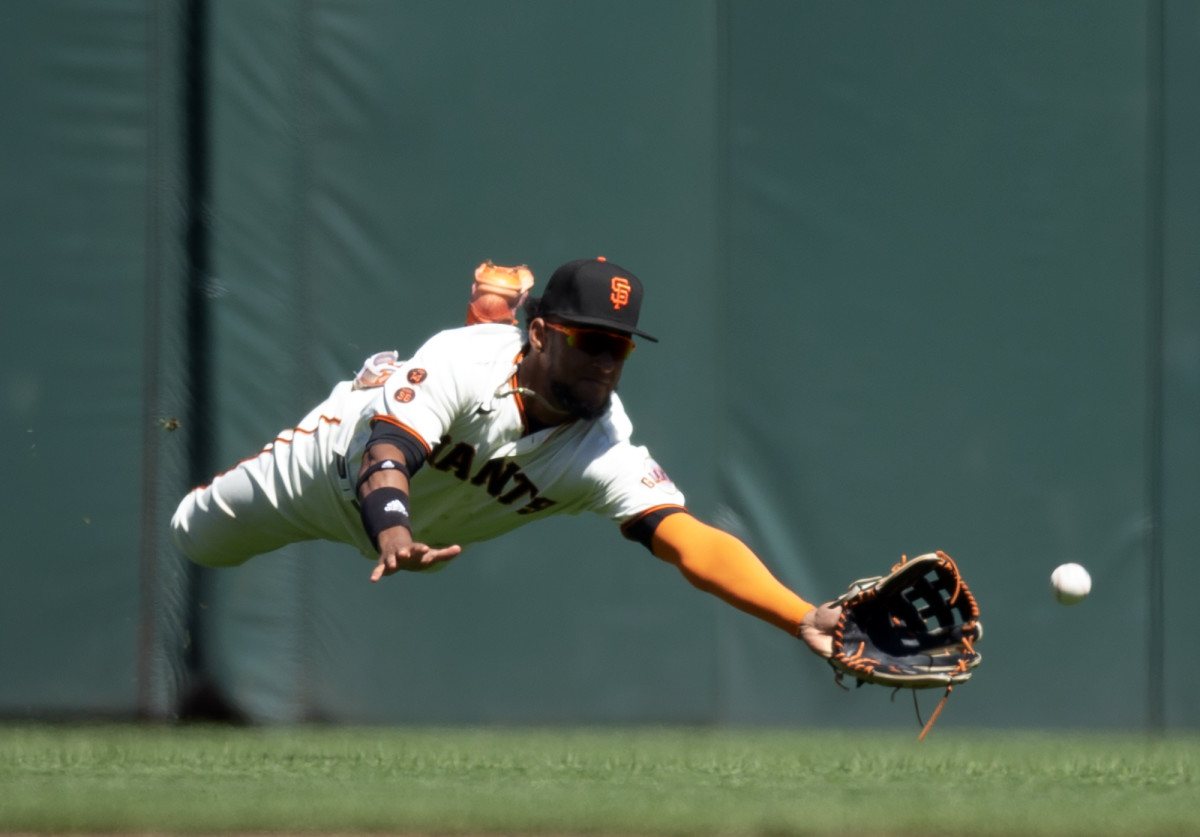 SF Giants center fielder Luis Matos makes a diving attempt to catch a double by a Boston Red Sox hitter on July 30, 2023.