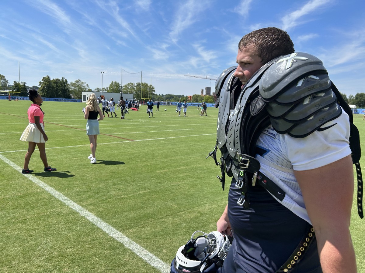 Titans rookie offensive lineman Peter Skoronski had to take care of his veteran teammates on Monday, carrying their shoulder pads and helmets off the practice field. (AllTitans.com photo by Tom Brew)