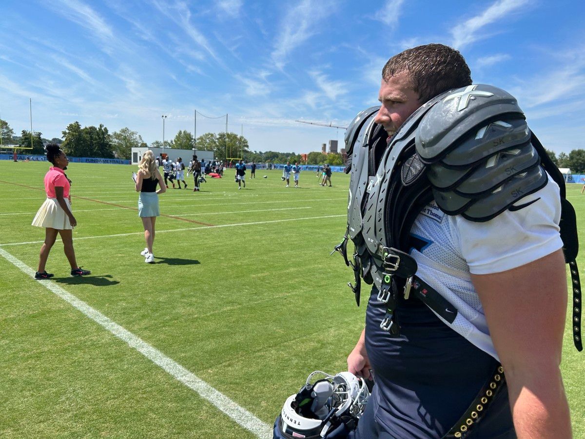 Titans rookie offensive lineman Peter Skoronski had to take care of his veteran teammates on Monday, carrying their shoulder pads and helmets off the practice field. (AllTitans.com photo by Tom Brew)